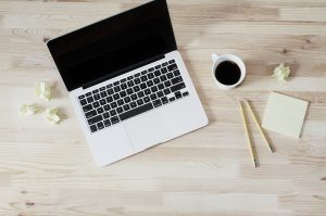 This image displays a laptop on a desk in preparation for a blog post