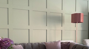 Wooden panels on a wall creating a square pattern. It is painted green.