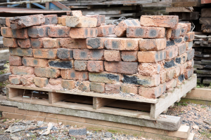 A pile of previously used bricks on a  pallet