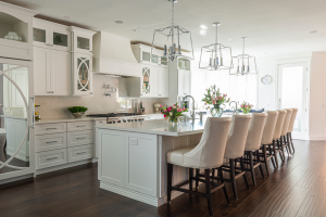 A fully white kitchen with a large island as the focus