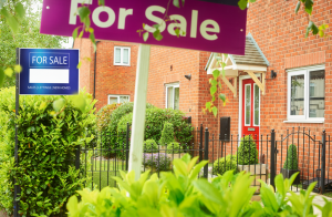 A for sale sign in front of a house