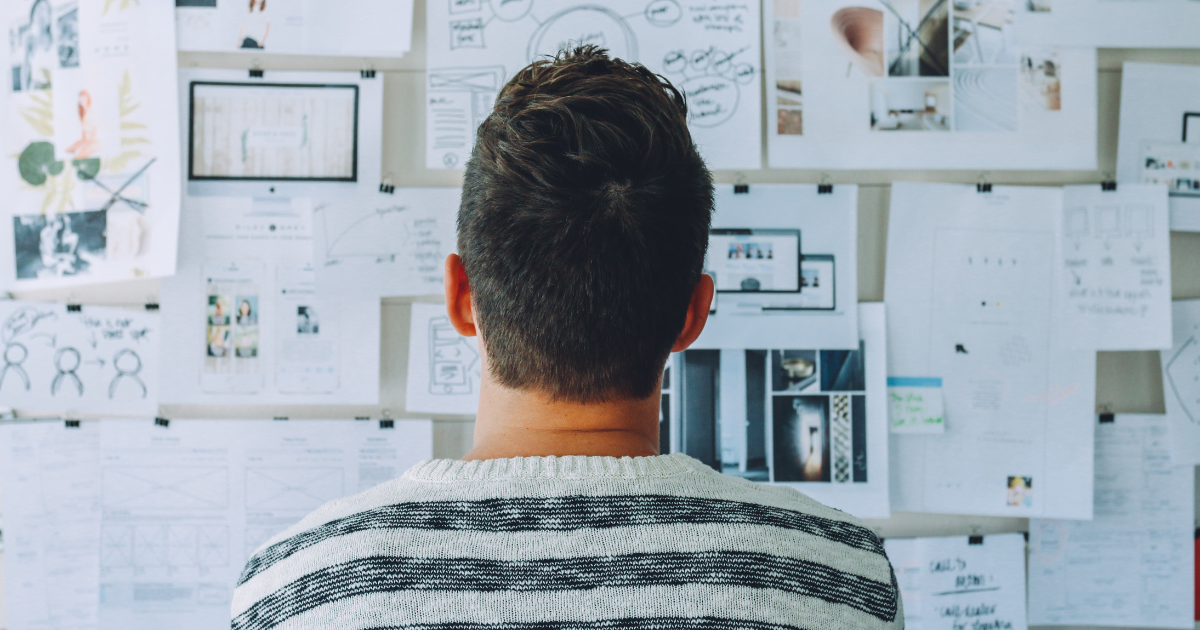 man looking at planning board.